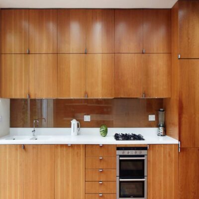 modular kitchen with veneer shutters and inbuilt microwave and oven installed in noida