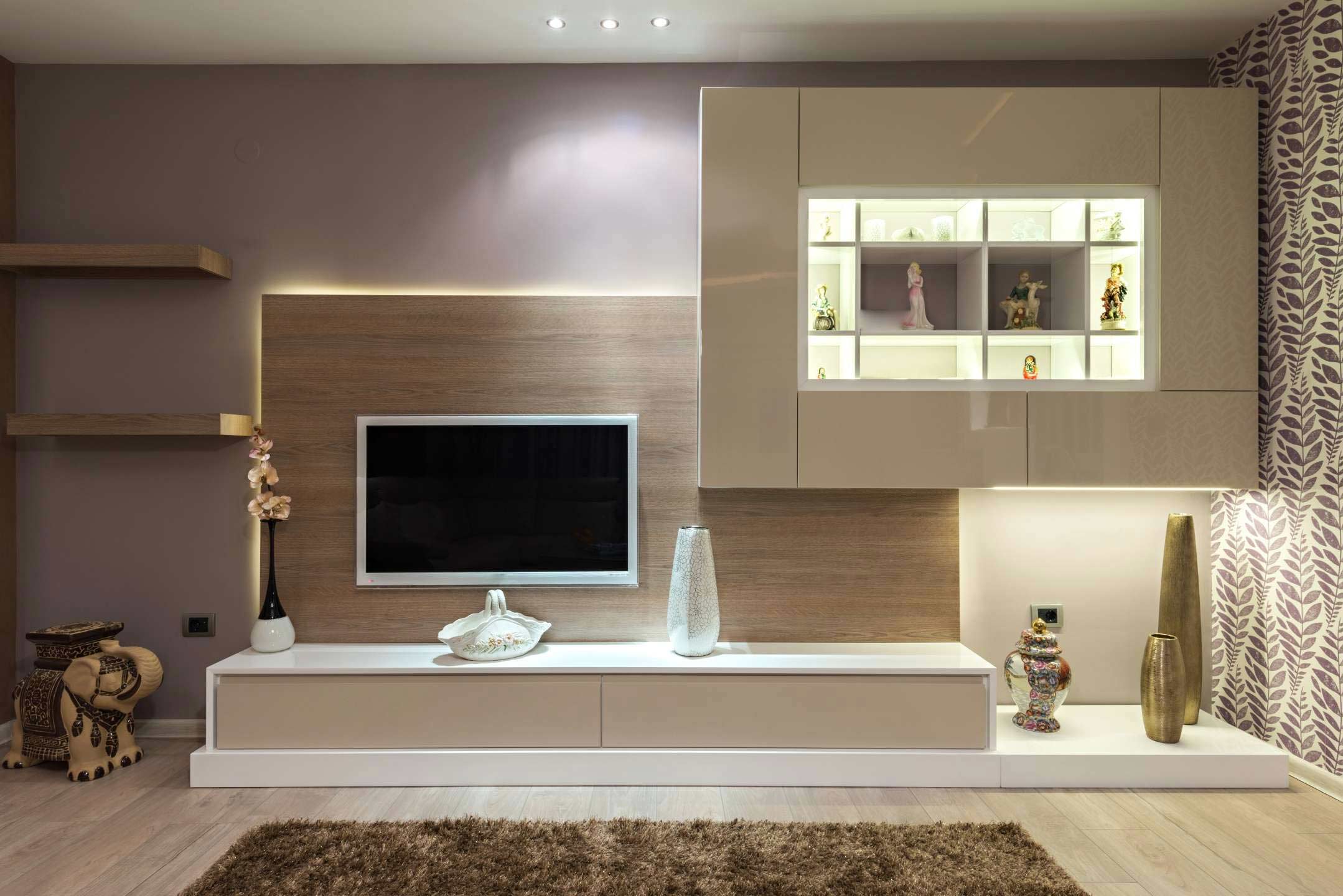 gorgeous tv unit with ample storage and a contemporary design with acrylics and laminates and lot of internal lights